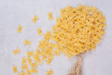 Beyaz arka planda buğdaylı çiğ farfalle makarna. Yüksek kalite fotoğraf