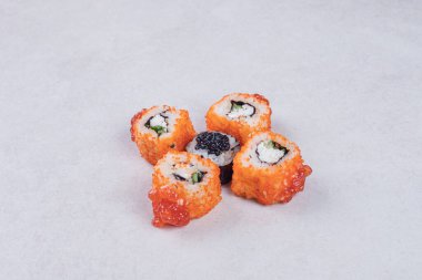 Maki ve California suşisi beyaz arka planda yuvarlanıyor. Yüksek kalite fotoğraf