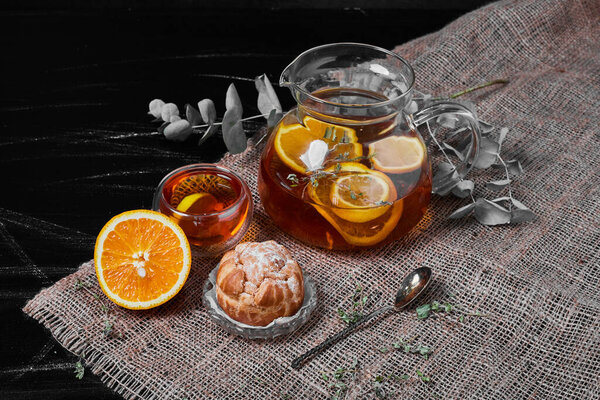 Puff pastry bun with lemonade on black background. High quality photo