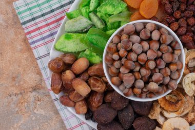 Beyaz tabakta çeşitli kurutulmuş meyve ve fındıklar. Yüksek kalite fotoğraf