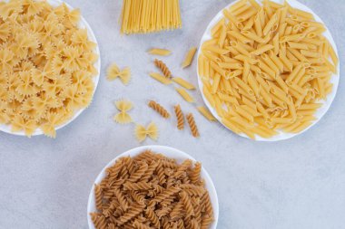 Beyaz arka planda çeşitli pişmemiş makarna. Yüksek kalite fotoğraf