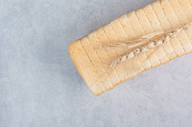 Ev yapımı ekmek dilimleri taştan arka planda buğdayla birlikte. Yüksek kalite fotoğraf