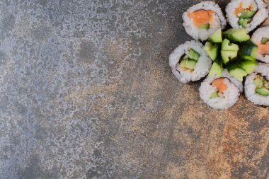 Mermer arka planda salatalıklı lezzetli suşi seti.