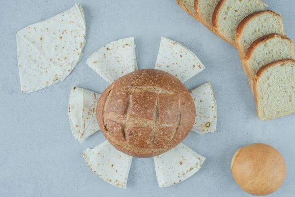 Variety of bread on stone background. High quality photo