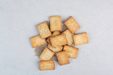 Beyaz arka planda çuval bezli lezzetli krakerler. Yüksek kalite fotoğraf