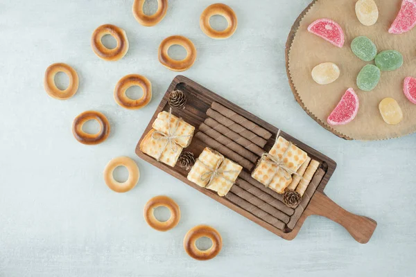 A wooden board full of pastries and marmalade on white background. High quality photo