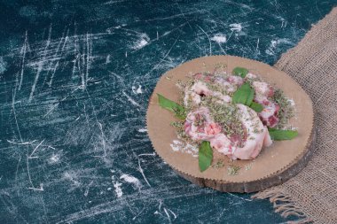 Çiğ et parçaları ve mavi fırında taze ve kurutulmuş otlar. Yüksek kalite fotoğraf