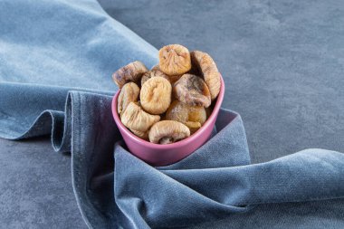 Kurumuş incirler bir kumaş parçasında, mermer arka planda. Yüksek kalite fotoğraf
