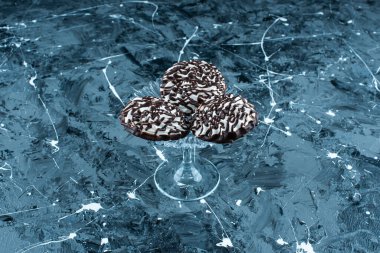 Cam kaidede çikolatalı kurabiyeler, mavi arka planda. Yüksek kalite fotoğraf