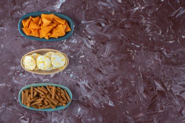 Mermer arka planda, kaselerde çeşitli cipsler. Yüksek kalite fotoğraf