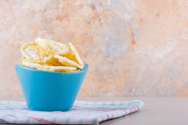 Beyaz masada mavi kase çıtır pirinç cipsi. Yüksek kalite fotoğraf