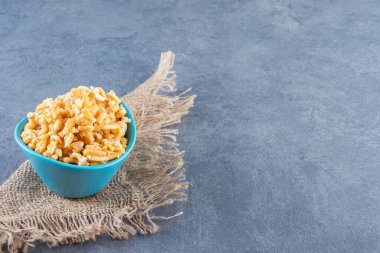 Tatlı karamel şekerler, mermer arka planda, dokuma üzerine bir kasede. Yüksek kalite fotoğraf