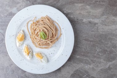 Beyaz tabakta haşlanmış yumurtalı spagetti. Yüksek kalite fotoğraf