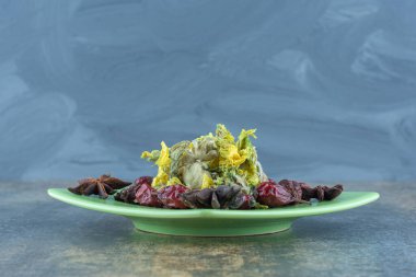 Kurumuş gül kalçası ve yeşil tabakta çiçekler. Yüksek kalite fotoğraf