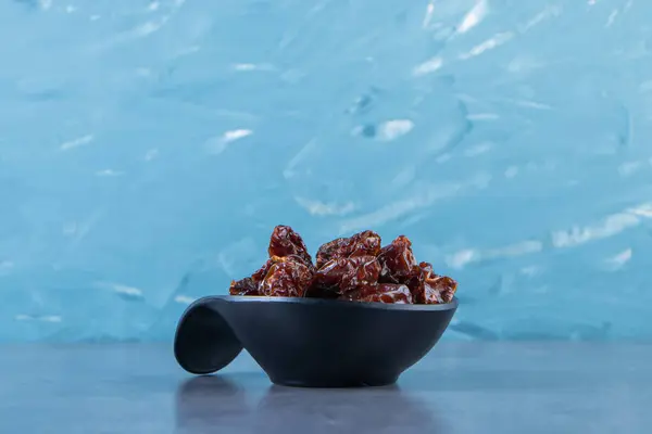 A bowl of dried plum, on the marble background. High quality photo