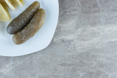 Gri arka planda beyaz tabakta ev yapımı turşunun en üst görüntüsü. - Evet. Yüksek kalite fotoğraf