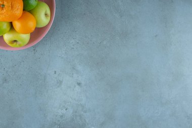 Mermer zemin üzerinde çeşitli meyvelerden oluşan bir tabak. Yüksek kalite fotoğraf