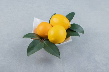 Beyaz tabakta taze sarı limonlar. Yüksek kalite fotoğraf