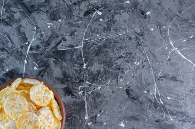 Tahta tabakta patates cipsi, mermer arka planda. Yüksek kalite fotoğraf