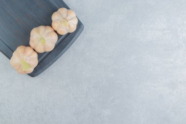 Ahşap tepside, mermer zemin üzerinde taze sarımsak. Yüksek kalite fotoğraf