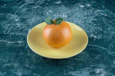 Portakallı bir tabak, mermer arka planda. Yüksek kalite fotoğraf