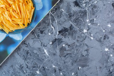 Tahta tabakta patates cipsi, mermer arka planda, bir kitapta. Yüksek kalite fotoğraf