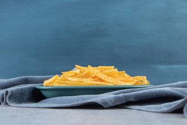 Mavi kumaş üzerinde çıtır çıtır patates çubukları. Yüksek kalite fotoğraf