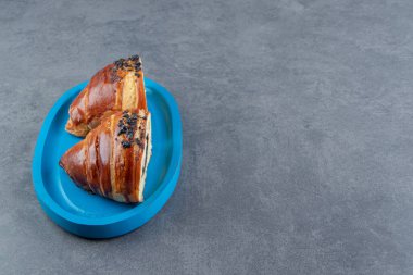 Mavi tabakta çikolatalı yarım dilim kruvasan. Yüksek kalite fotoğraf