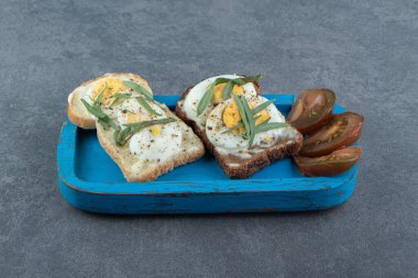 Mavi tabakta haşlanmış yumurtalı ekmek. Yüksek kalite fotoğraf