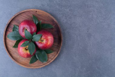 Elma ve yapraklar tahtada, mermer zeminde. Yüksek kalite fotoğraf