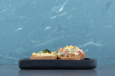 Salatalı ekmek ve siyah tabakta yumurta. Yüksek kalite fotoğraf