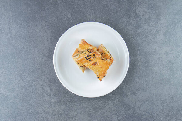 Bun stuffed with meat on white plate. High quality photo