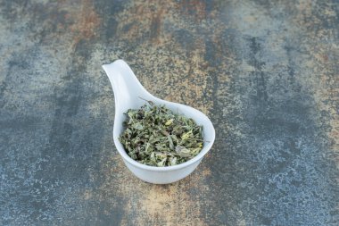 Beyaz kasede kurutulmuş çay yaprakları. Yüksek kalite fotoğraf