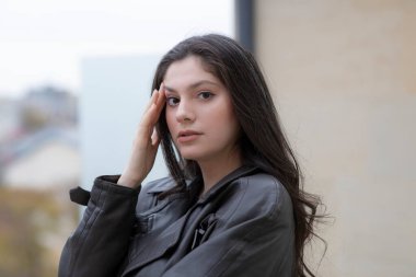 Terasta kameraya bakarken genç esmer bir kızın görüntüsü. Yüksek kalite fotoğraf