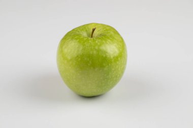 Single fresh green apple placed on white background. High quality photo