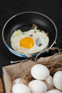 Kızartma tavasında ve yumurta sepetinde kızarmış yumurtalarla nefis bir kahvaltı. Yüksek kalite fotoğraf