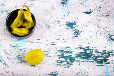 Mermer yüzeyde siyah kase kırmızı biber turşusu. Yüksek kalite fotoğraf