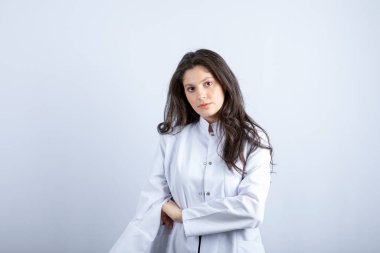 Photo of young doctor posing and standing on white background. High quality photo