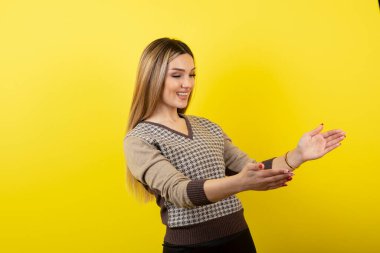 Ayakta duran ve açık alan tutan genç bir kadının portresi. Yüksek kalite fotoğraf