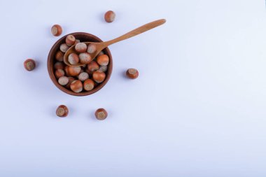 Beyaz arka planda bir kase organik fındık ve kaşık. Yüksek kalite fotoğraf