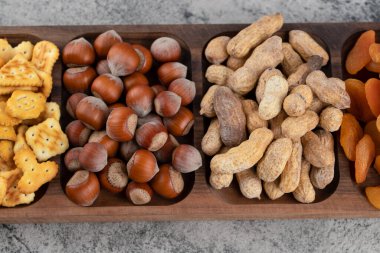 Tahtada fındıklı çıtır krakerler ve kabuklu fıstıklar. Yüksek kalite fotoğraf