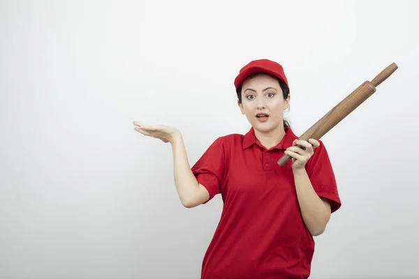 Young Woman Red Uniform Rolling Pin Showing Opened Palm High — Stock Photo, Image