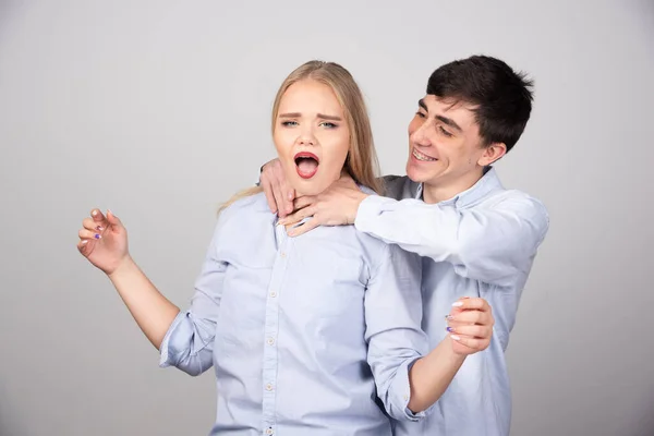 Mann Hält Frau Hals Gegen Graue Wand Hochwertiges Foto — Stockfoto