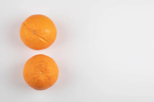 Két Teljesen Friss Narancs Fehér Felületre Helyezve Kiváló Minőségű Fénykép — Stock Fotó