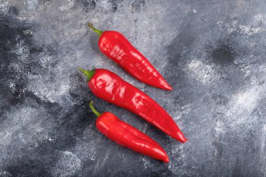 Red fresh chili peppers placed on marble surface. High quality photo