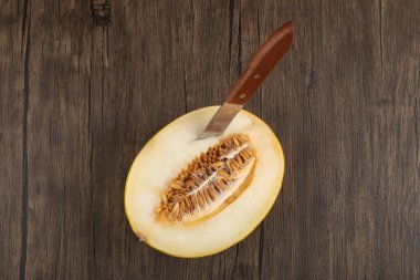 Tahta bir masada bıçakla dilimlenmiş taze olgun kavun meyvesi. Yüksek kalite fotoğraf