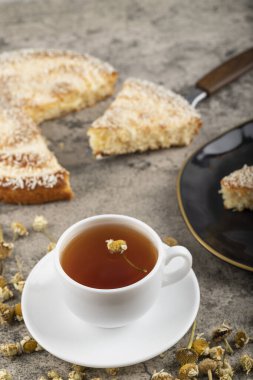 A cup of tea with dried flowers placed on stone table. High quality photo