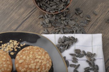 Tahta bir masanın üzerine yerleştirilmiş tahtadan bir kasede ayçiçeği tohumları. Yüksek kalite fotoğraf