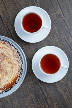 Tahta bir masaya siyah çay konmuş bir tabak lezzetli turta. Yüksek kalite fotoğraf