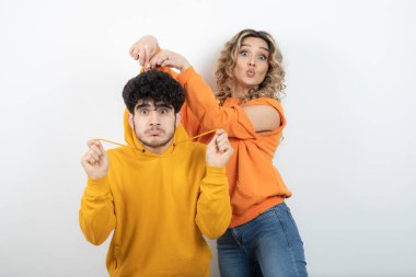 Güzel sarışın kıvırcık kadın erkek arkadaşının saçıyla oynuyor. Yüksek kalite fotoğraf